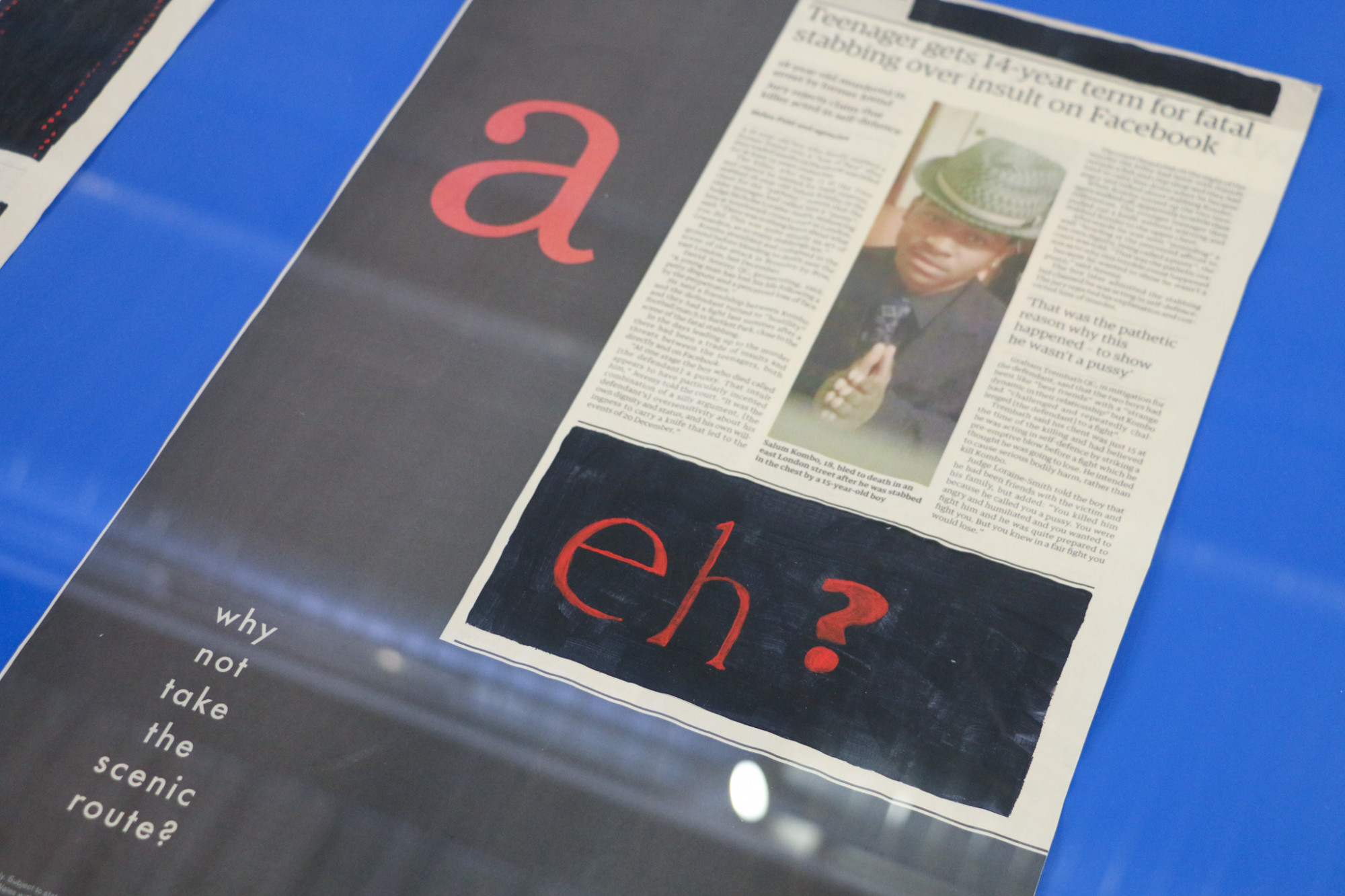 A close up of a single page from the Guardian newspaper which shows the image of a black man with the article title 'Teenager gets 14-year term for fatal stabbing over insult on Facebook' and a large column with a single 'a' sits nexts to it. Another section has been painted over and the text 'eh?' in red overlaid.