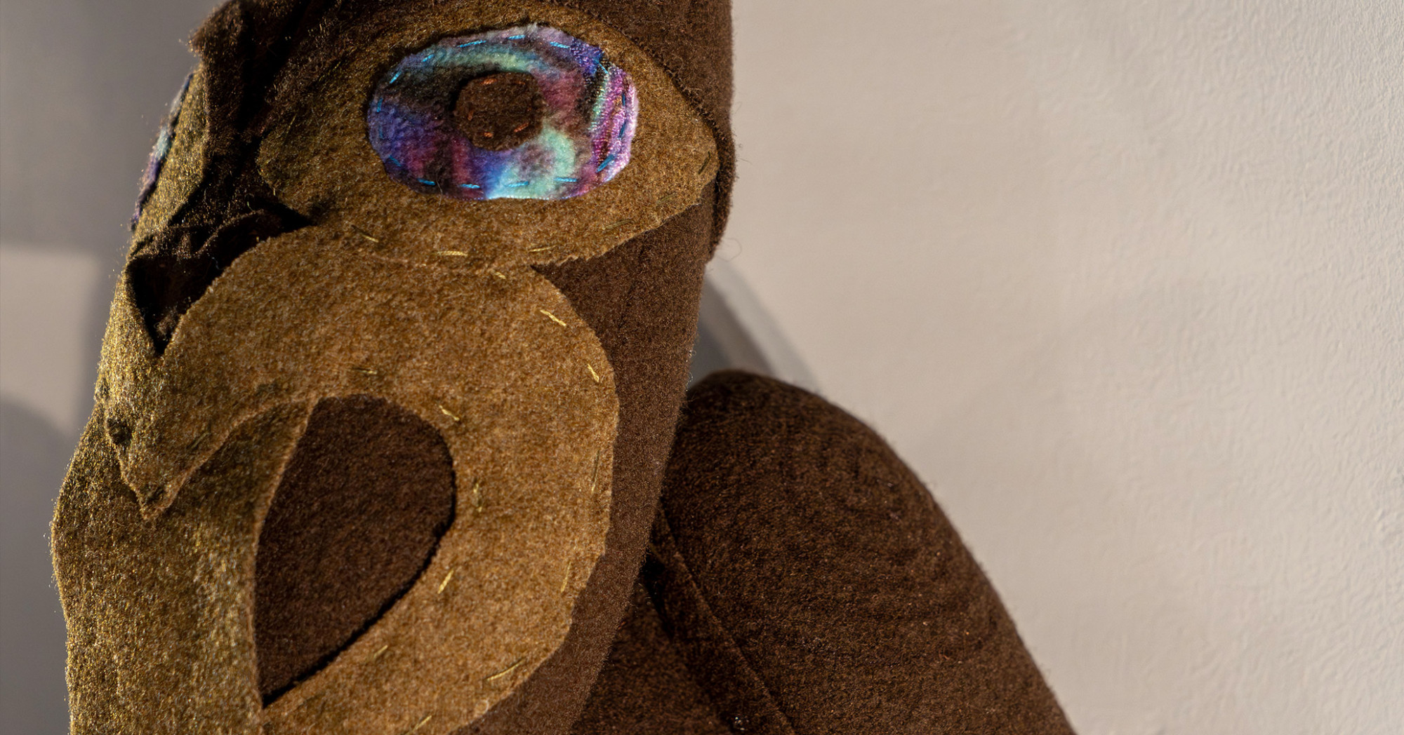 A dark brown tekoteko soft toy