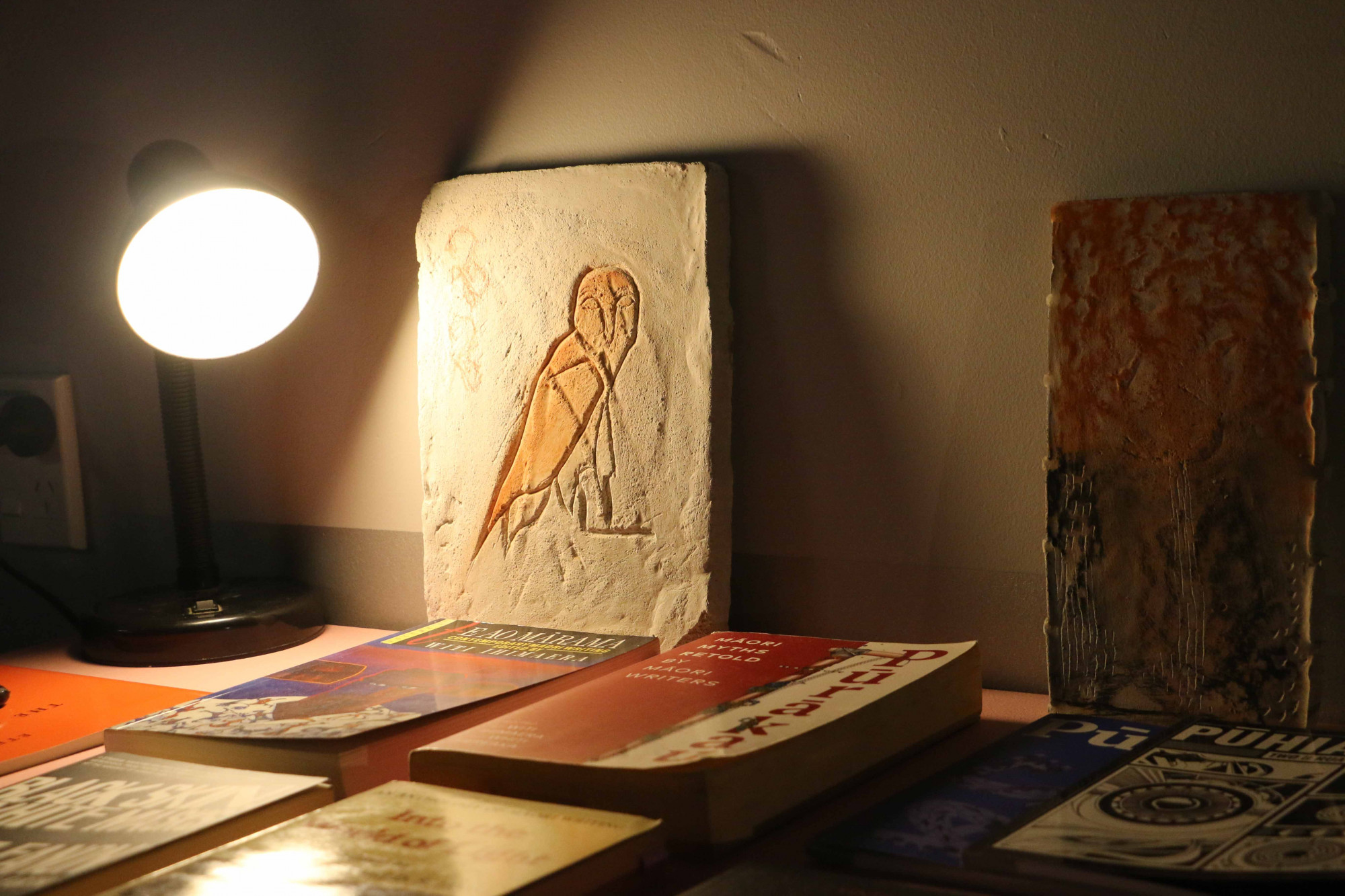 A piece of concrete with a carved ruru