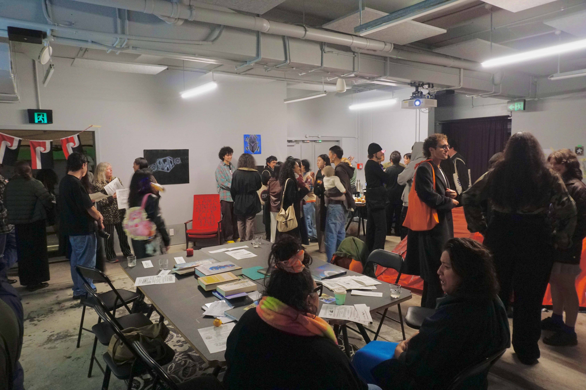 Small groups of  people talking to each other at different corners of the space.